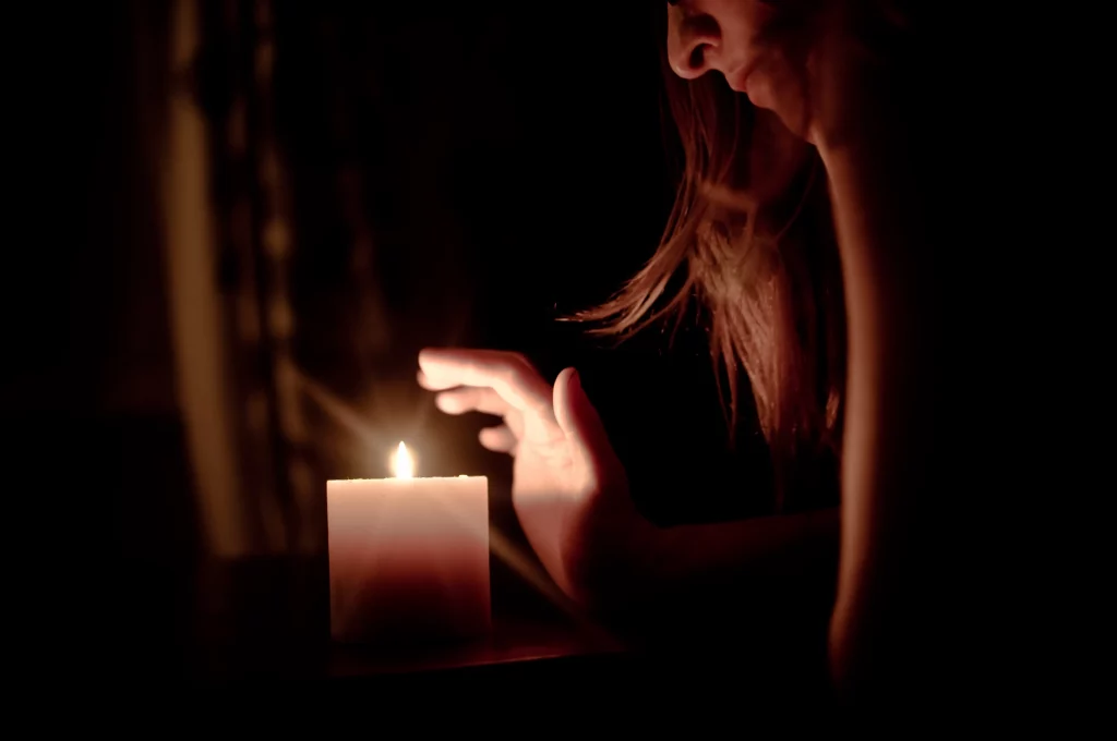 woman in front of candle